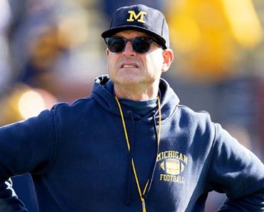 Jim Harbaugh helps clear fallen tree in Michigan ice storm